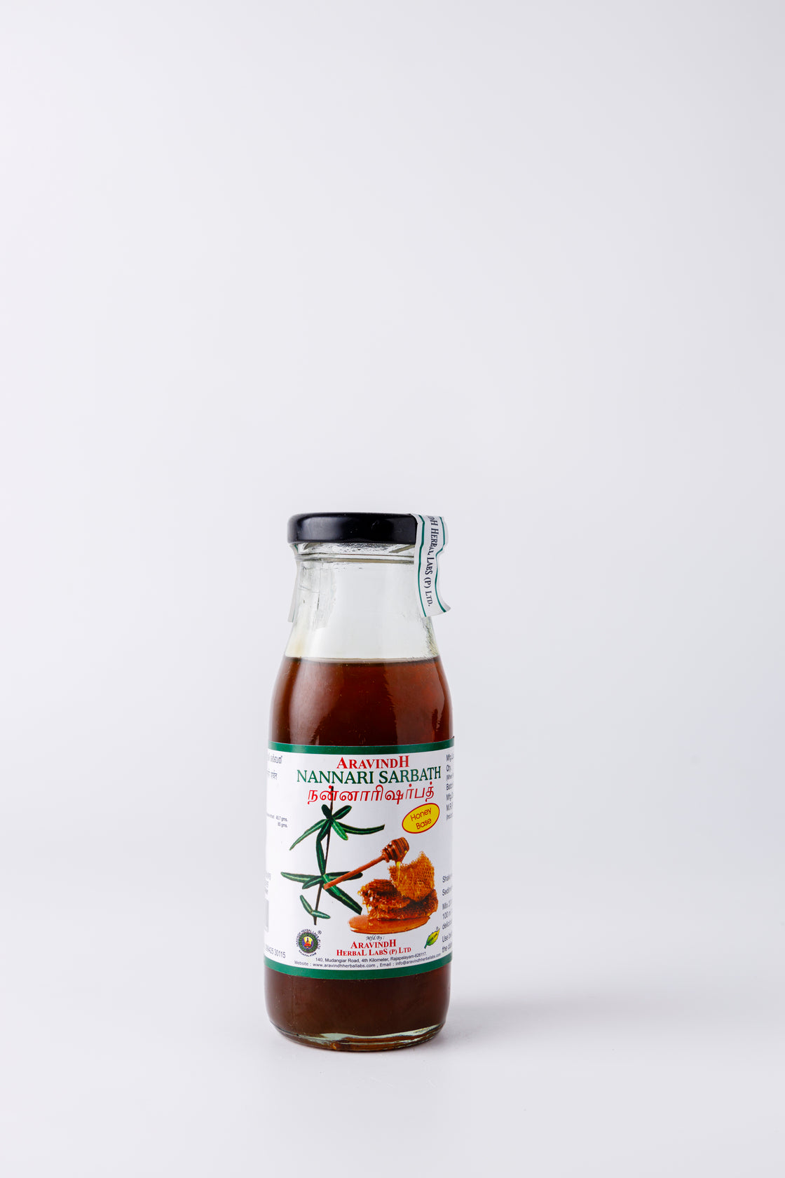 Pouring Nannari Sarpath (honey) into a Glass