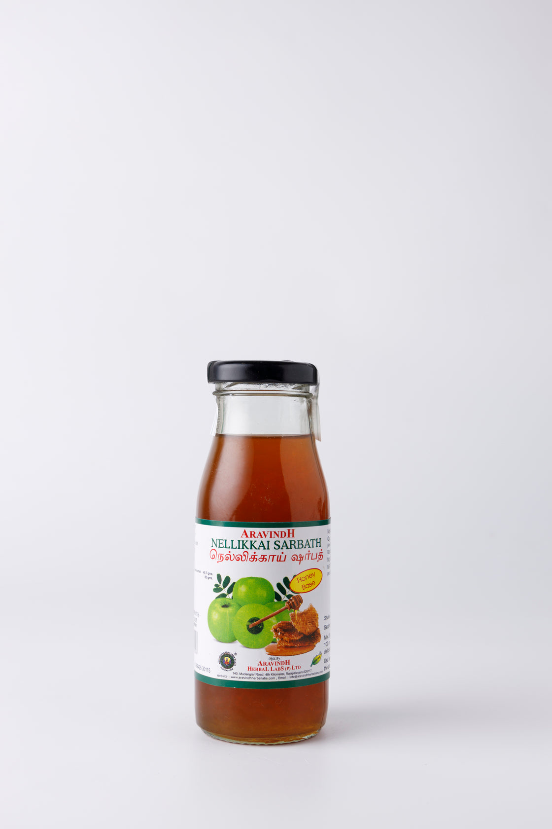 Pouring Amla Sarpath (honey) into a Glass