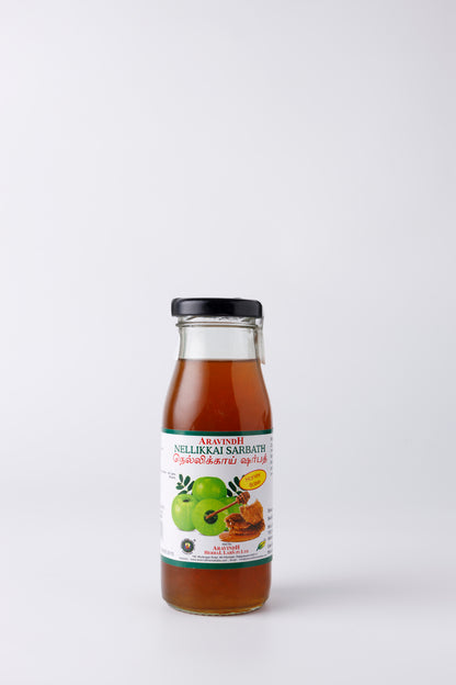 Pouring Amla Sarpath (honey) into a Glass